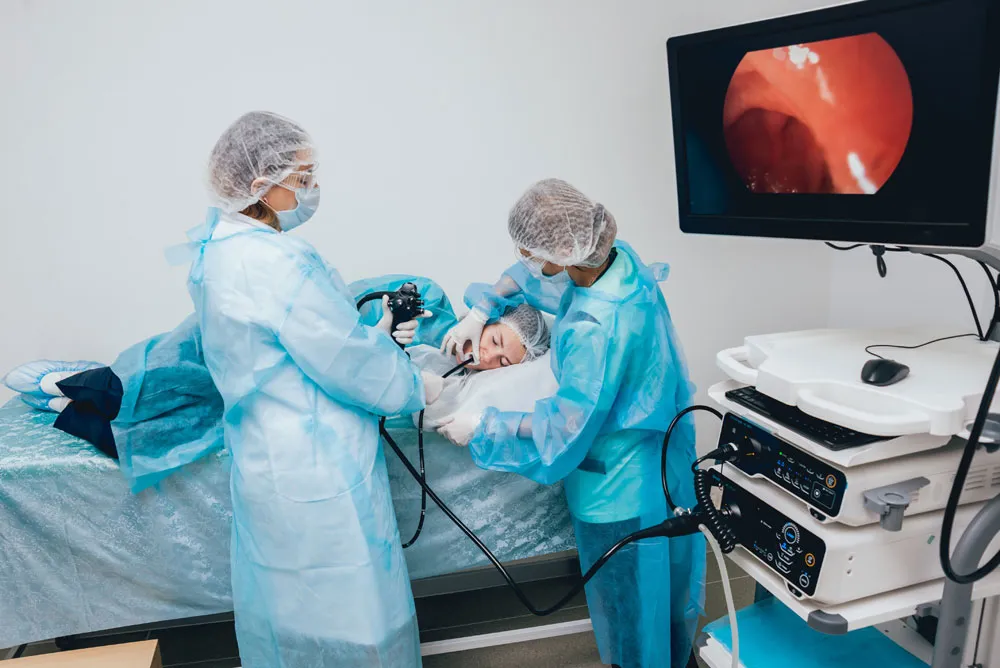 Doctors performing endoscopy on patient