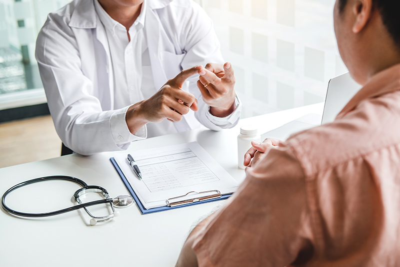 Doctor explaining to a male patient the results of his colonoscopy.