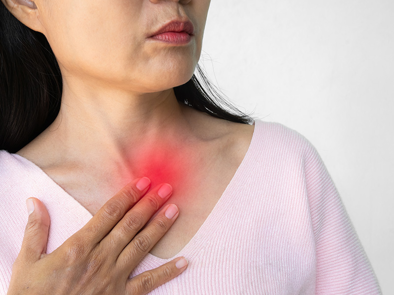 Woman experiencing discomfort in her throat